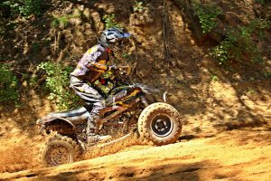 ATV Rider in mud riding through mountains